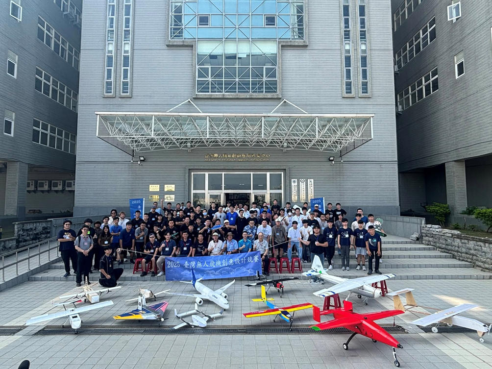 Group photo of participants and UAV designs